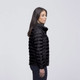 A black puffer jacket with a high collar, featuring a sleek design and a logo on the front.