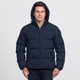 A navy puffer jacket with a hood, featuring a zip front and side pockets. The model is wearing it. A navy puffer jacket with a hood, featuring a zip front and side pockets. The model is wearing it.