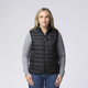 A black padded baffle vest features zippered pockets and is worn over a grey long-sleeve shirt.
