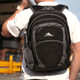 A black and grey backpack with multiple compartments and a side mesh pocket, featuring a logo on the front.