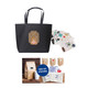 A black paper bag with handles featuring a design and an assortment of stickers in various colours.