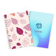 A5 full colour wiro binding notebook featuring a leaf pattern in pink and a gradient blue cover with a logo.