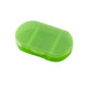 A green, oval pill box with three separate compartments and a secure lid. It has a simple, transparent design.