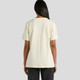 A cream-coloured t-shirt featuring a simple design, with short sleeves and a relaxed fit. It includes a logo on the back.