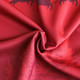 A red polyester and spandex fabric featuring festive designs, suitable for Christmas sweatshirts.