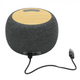A round, grey wireless speaker with a bamboo top and a USB connection cable. It features a logo on the body.