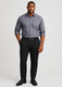 A man wearing a grey shirt and black modern stretch chino pants, paired with black shoes and a belt.