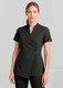A woman is wearing a black spa tunic with a wrap design and short sleeves. The tunic features a simple button detail.