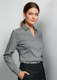 A woman models a grey long sleeve button-up shirt, featuring a collar and a fitted design. The shirt has branding.