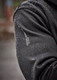 A close-up of a black water-resistant hoodie with a logo on the sleeve, featuring droplets of water on the fabric.