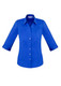 A blue ladies' button-up shirt with 3/4 sleeves and a fitted design. The shirt features a collar and buttons. A blue ladies' button-up shirt with 3/4 sleeves and a fitted design. The shirt features a collar and buttons.