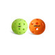 Two pickleball balls, one green and one orange, both featuring multiple holes and a logo on the green ball.