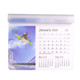 A mouse mat featuring a calendar for January 2025, with a vibrant image of a snowboarder and purple tones.