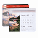 A calendar mouse mat featuring a scenic landscape design with a monthly calendar layout, predominantly in blue and white tones.