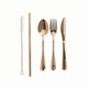 A set of rose gold cutlery including a spoon, fork, knife, and reusable straw with a cleaning brush.