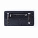 A black pin backing with two chrome clasps and a central safety pin attachment.