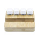 A bamboo stand holder featuring four white key pressing stress relievers on top. A bamboo stand holder featuring four white key pressing stress relievers on top.