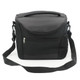 A black cooler bag with a shoulder strap and zippered compartments, featuring a mesh side pocket and a top handle.