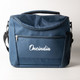 A navy cooler bag with a front zip pocket and a mesh side pocket, featuring a logo.