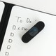 A5 whiteboard notebook with a black cover and a dark blue eraser on a handwritten to-do list.