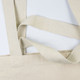 A beige tote bag with textured straps and a simple design, featuring a logo. A beige tote bag with textured straps and a simple design, featuring a logo.