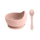 A pink silicone kids suction bowl with a matching spoon and a logo. The bowl features a built-in suction base.
