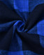 A close-up of unisex flannel plaid fabric in shades of blue and black, featuring a traditional check pattern.