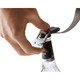 A drink bottle is being secured with a grey strap and clip, designed for use with the Bellroy Lite Cooler Caddy 10L.