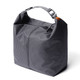 A grey cooler bag with a minimalist design, featuring a top handle and a zip closure, alongside a branding logo.