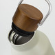 A drink bottle featuring a cream exterior and a wooden top handle, with a stainless steel interior.