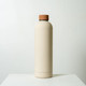 A drink bottle in a soft beige colour with a brown lid, featuring a smooth matte finish and a logo. A drink bottle in a soft beige colour with a brown lid, featuring a smooth matte finish and a logo.