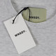 A grey essential tee with a tag and label featuring a logo. A grey essential tee with a tag and label featuring a logo.