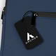A navy blue soft-touch laptop sleeve featuring a zippered pocket and a branded tag.