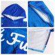 A blue cotton sublimation hoody towel surf poncho featuring a hood and contrasting inner lining. It has a logo.