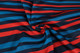 A fabric featuring horizontal stripes in red, blue, and navy, ideal for a sublimated sport long sleeves polo.