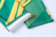 Green and yellow unisex adult sports shorts with a dotted pattern and logo. Features a sublimated design.
