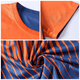 A reversible jersey featuring orange and navy colours with striped patterns and a logo. Detailed views of neck and sleeve included.
