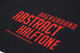 A black sports short with a bold red abstract halftone design and a logo.