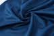 A close-up of dark navy polyester fabric, showcasing its smooth and soft texture.