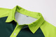A green and lime RPET sublimated raglan polo shirt featuring a collar and buttons, with a branded logo.