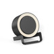 A round black night light speaker with a wireless charging stand. The product features a light ring around the top edge.