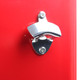 A chrome bottle opener attached to a bright red surface, designed for convenience in outdoor settings.