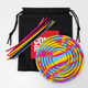 A sensory activity board in rainbow colours with multiple colourful rods, packaged in a black drawstring bag featuring a logo.