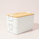 A double stack lunch box in white with a bamboo lid, featuring two compartments and a branded logo.