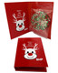 A red gift card featuring a reindeer design, with a chocolate disc decorated in red, green, and white sprinkles inside.