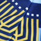 A close-up of a soft blue and yellow patterned fabric featuring geometric designs.