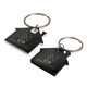 Two house-shaped keytags in black and white, featuring a keyring and a logo on each.