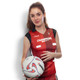 A netball top in red and black with a logo, worn by a model holding a netball.