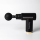 A black massage gun with a rounded attachment, featuring gold accents and a logo on the side.