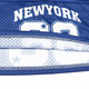 A blue sports jersey featuring a mesh design and a logo. The jersey includes a number and is made from 100% polyester.